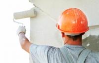 Worker painting a wall
