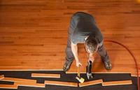 Worker installing new interior flooring